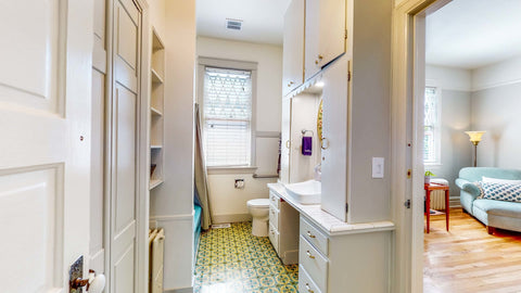 Inside the Secretary's Suite — queen bed and tall windows